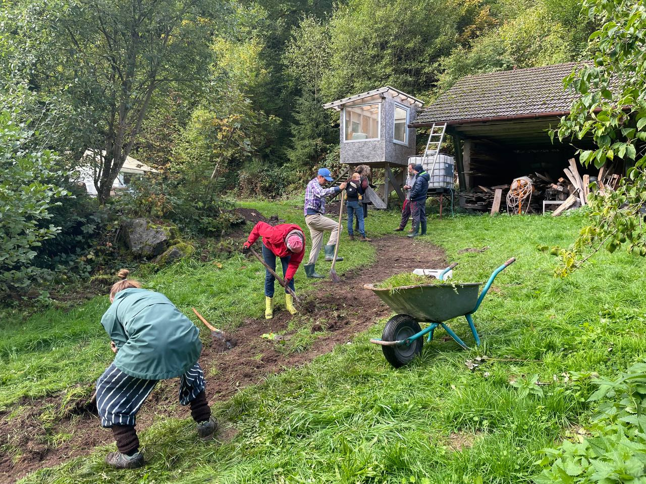 Permaculture Workshop, People create a path with gardening tools